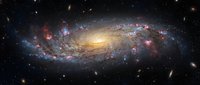 Spectacular spiral galaxy with glowing arms and bright central core against deep space background filled with distant stars and cosmic dust clouds.