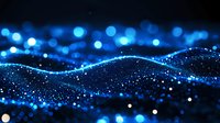 Glowing blue particles form dynamic waves against dark background, creating futuristic digital landscape with bokeh light effects and depth of field.