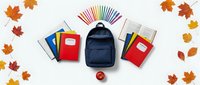 School supplies with backpack, notebooks, colored pencils and apple arranged on white background surrounded by autumn leaves for back to school season.