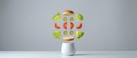 Modern kitchen blender with fresh vegetables and fruits floating around showing healthy smoothie ingredients on clean white background.