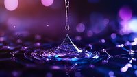 Mesmerizing water drop splash creating ripples against purple and blue bokeh background, captured in macro with frozen motion showing liquid surface tension.