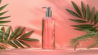 Minimalist cosmetic bottle with silver pump dispenser on coral pink background with tropical palm leaves casting soft shadows. For beauty product mockup.