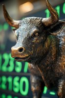 Bronze bull statue against digital stock market display showing green numbers, symbolizing bullish market trends and financial growth on Wall Street.