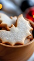 Golden star-shaped cookies dusted with powdered sugar in wooden bowl, festive holiday baking treats for Christmas celebration and winter dessert preparation.
