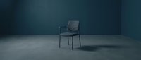 Modern gray chair with armrests positioned in minimalist concrete interior space, suitable for furniture design, architectural visualization, and contemporary home decor projects.