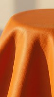 Vibrant orange leather texture with soft folds and natural grain detail, showcasing material quality for fashion, upholstery, and design projects.
