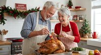 Happy senior Caucasian couple preparing Christmas turkey dinner together in festive kitchen with holiday decorations and garland.