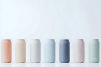 Row of pastel colored aluminum cans with water droplets on white background, minimalist design for beverage packaging mockup.