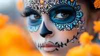 Artistic sugar skull makeup in turquoise and silver with rhinestone details against orange blurred background. Close up portrait showcasing detailed Day of Dead celebration style.