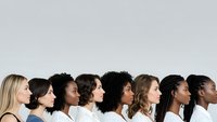 Diverse group of women in profile showing multicultural beauty and unity in professional studio setting on neutral background.