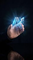 Businessman hand holding glowing holographic shopping cart with upward arrow and dollar signs representing ecommerce growth and digital sales success.
