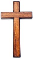 Wooden cross with rich brown grain texture isolated on white background. Religious symbol crafted from natural wood showing detailed woodwork and warm tones.