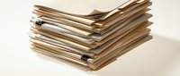 Stack of old documents and papers with worn edges isolated on white background, suitable for office, archive, and business design projects.