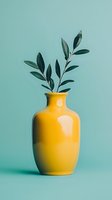 Green olive branches in bright yellow ceramic vase against mint background. Minimalist home decor composition with clean lines and contrasting colors.