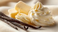 Creamy butter, whipped vanilla frosting, and aromatic vanilla pods on soft white fabric background. Perfect for dessert recipes and baking concepts.