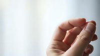 Open cupped hands in gentle receiving gesture against soft light background for prayer meditation and spiritual concepts.