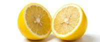 Two fresh lemon halves with visible pulp and seeds isolated on white background, ready for food and beverage design projects.
