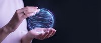 Hand holding glowing digital sphere with blue neon lines on dark background, representing technology, data, innovation, and digital transformation for business concepts.