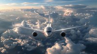 Commercial passenger aircraft flying above dramatic cloudscape during sunset, front view perspective. Perfect for aviation, travel and transportation themes.