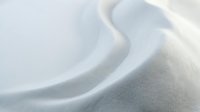 Soft white fabric with gentle folds and smooth texture creating elegant waves and curves for luxury textile and fashion design projects.