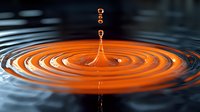 Orange water drop impact creating concentric ripples on liquid surface with multiple droplets suspended in air, captured in high-speed macro photography against dark background.