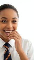Young African American businesswoman smiling confidently in professional attire with striped tie, hand near chin in thoughtful pose on white background.