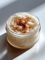 Homemade coffee body scrub with cinnamon in glass jar, natural skincare product for exfoliation and skin rejuvenation.