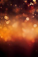 Magical orange and red bokeh lights on dark background with glowing particles create dreamy atmospheric effect for holiday designs and celebrations.