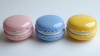 Three colorful macarons in pink, blue and yellow arranged on white background. French pastry dessert cookies with smooth shells and cream filling.