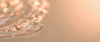 Clear crystal glass with elegant cut patterns reflecting warm golden light creating luxurious ambiance for premium beverage service and fine dining experiences.