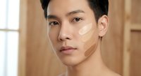 Young Asian man applying facial cream skincare routine grooming self-care male beauty wellness moisturizer cosmetics bathroom morning ritual healthy skin.