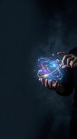 Businessman hands holding glowing atomic structure with orbiting electrons and particles on dark background for science and technology concepts.