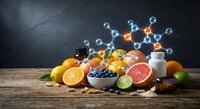 Fresh citrus fruits and berries with floating molecular structure representing vitamin C and antioxidants on rustic wooden table against dark background.