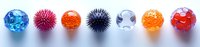 Colorful sensory stress balls and fidget toys lined up in row showing variety of textures including spiky, gel, and squeeze types on light background.