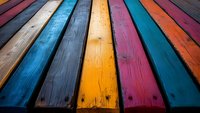 Vibrant multicolored wooden planks in perspective view create dynamic pattern. Weathered boards painted in blue, yellow, pink and orange showcase rustic texture and grain.