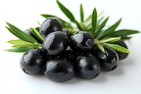 Fresh black olives with water drops and green olive leaves on white background, macro food photography for Mediterranean cuisine and healthy eating.