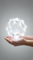 Hands holding glowing geometric crystal sphere with prismatic light effects on gray background for technology and innovation concepts.