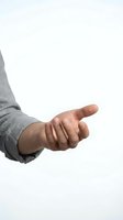Male hand in gray sweater reaching out with open palm gesture isolated on white background for presentation and design use.