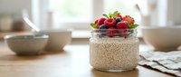 Overnight oats with fresh berries in glass jar on wooden table, healthy breakfast with strawberries and blueberries.
