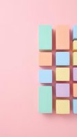 Colorful pastel geometric blocks arranged on pink background creating modern minimalist composition for creative projects and contemporary design layouts.