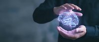 Businessman hands protecting glowing digital brain hologram representing artificial intelligence, mental health care, innovation and cognitive technology solutions.