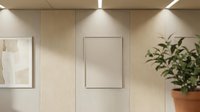 Modern minimalist interior with blank frame on wooden wall panel, green plant in terracotta pot, perfect for mockup presentations and home decor concepts.