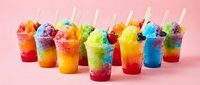 Colorful layered shaved ice drinks with straws arranged on pink background, perfect for summer beverage, refreshment, and dessert designs.