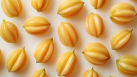 Yellow striped melon seeds arranged in rows on white background, fresh organic produce pattern for healthy eating and natural food design.