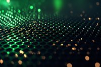 Abstract green and gold bokeh pattern on dark background with selective focus creating futuristic technology network visualization effect.