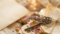 Vintage brass key with ornate handle surrounded by dried rose petals and old handwritten letters creating romantic nostalgic atmosphere for wedding invitations.