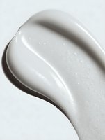 Smooth white cosmetic cream texture with glossy surface and subtle sparkle, ideal for skincare product advertising and beauty marketing.