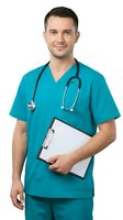 Male healthcare professional wearing turquoise scrubs and stethoscope, holding clipboard on white background. Suitable for medical, hospital, and healthcare industry applications.