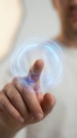Hand holding glowing holographic sphere with digital energy rings floating above palm showcasing futuristic technology and innovation concepts.