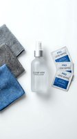Screen cleaning kit with spray bottle, microfiber cloths and lens wipes on white background for electronics maintenance and device care.